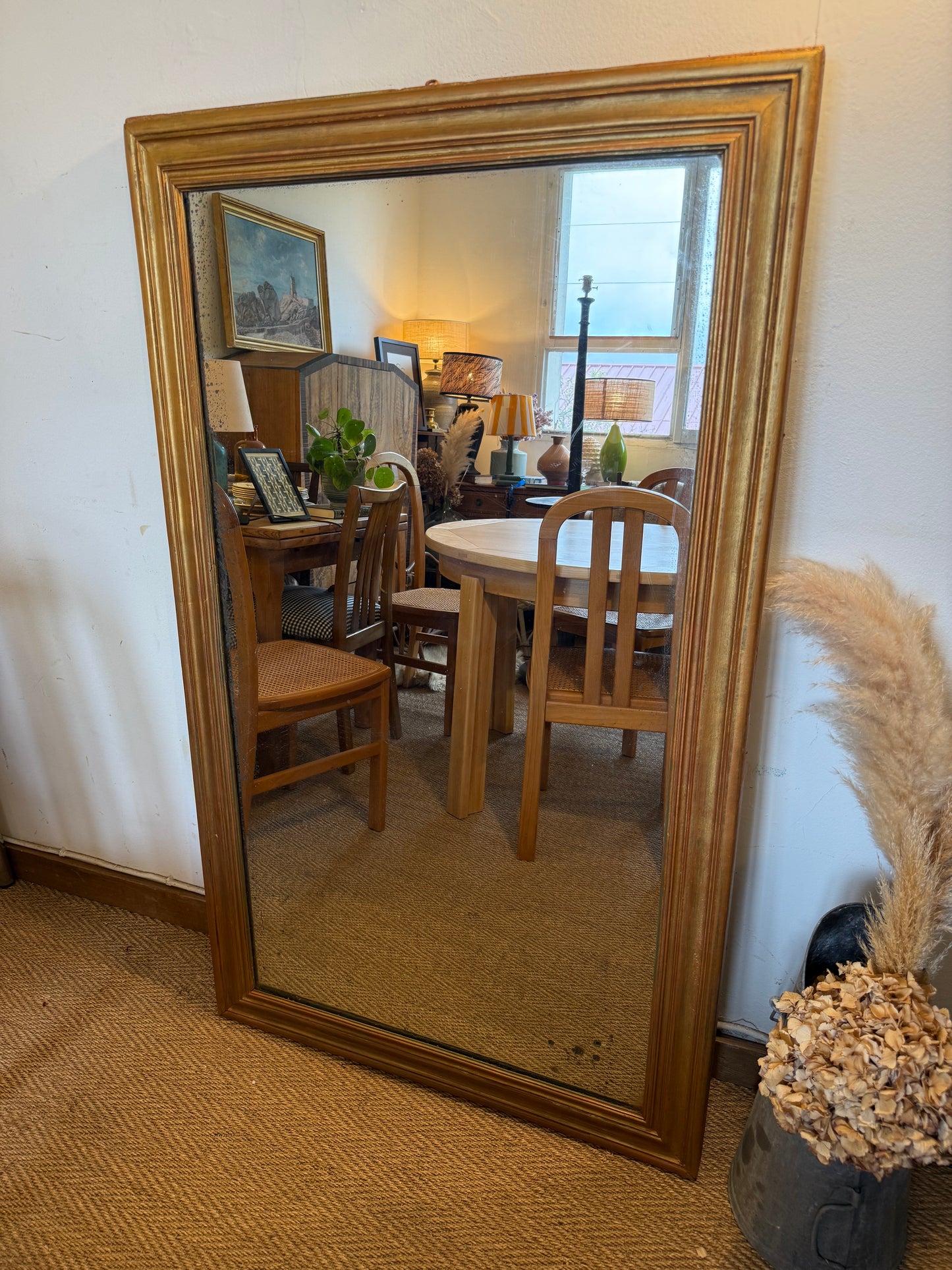 Grand miroir ancien en bois patiné doré