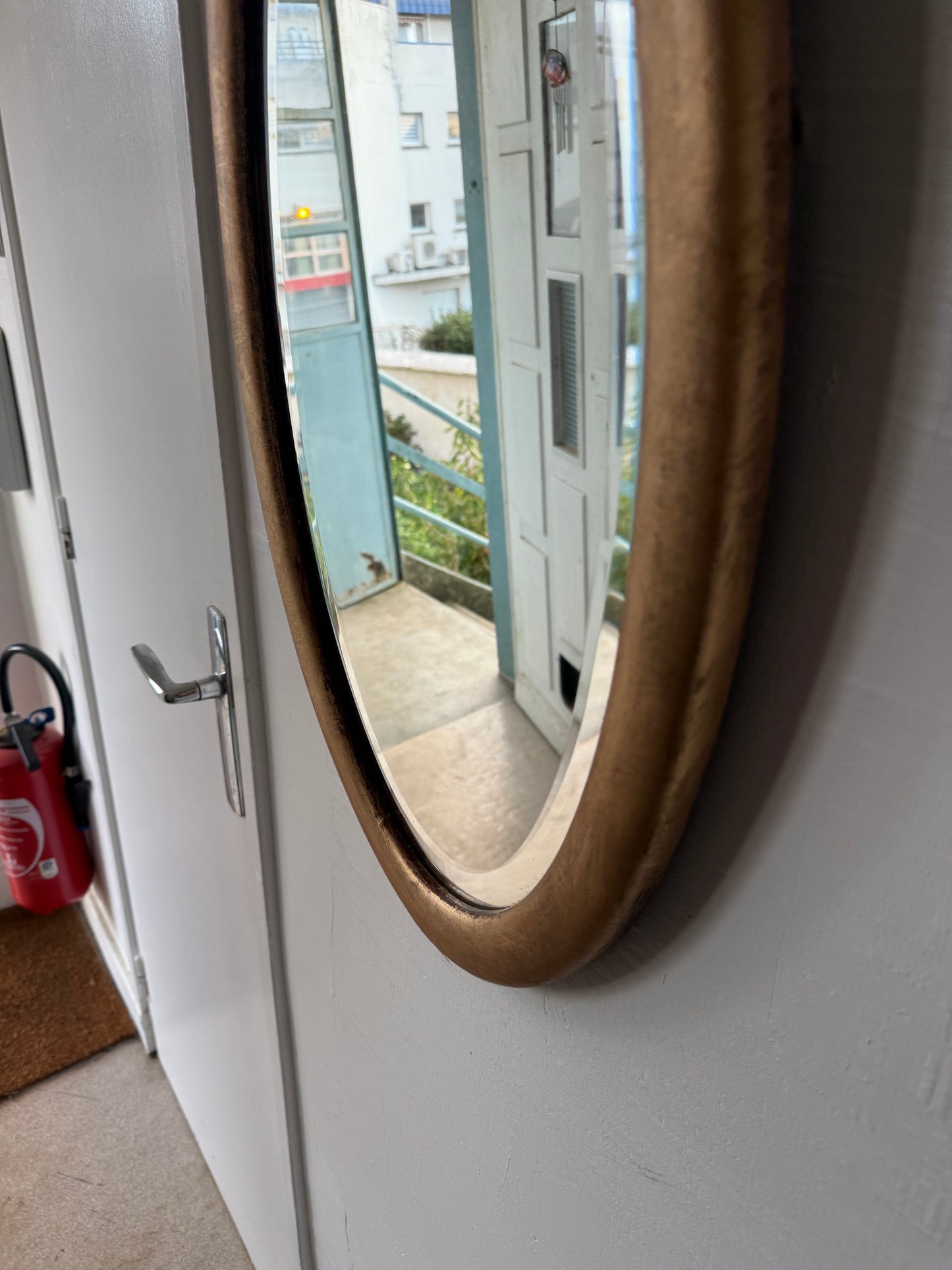 Miroir doré ovale ancien glace biseautée