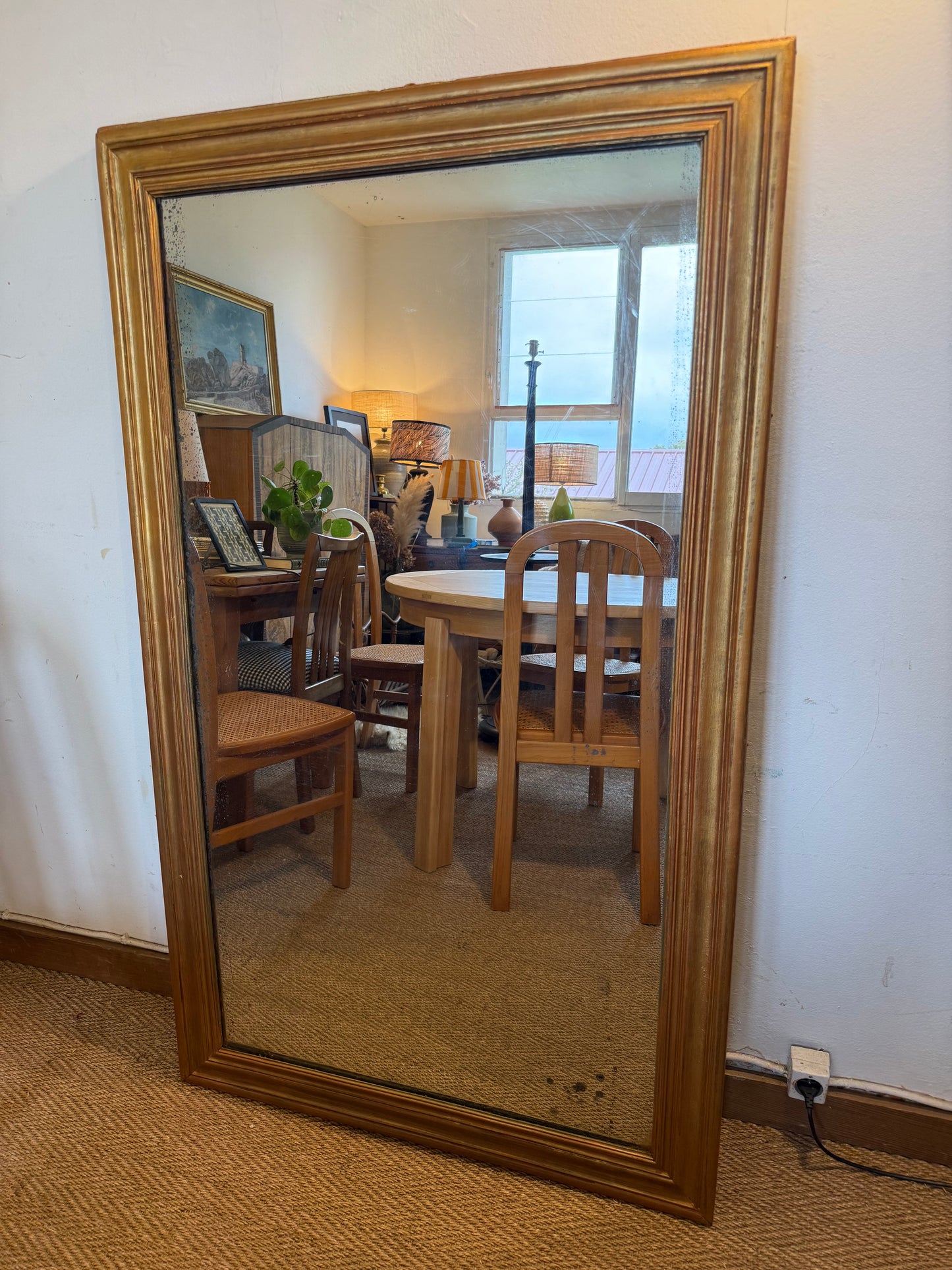 Grand miroir ancien en bois patiné doré